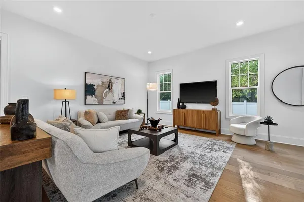 a living room with furniture and view of kitchen