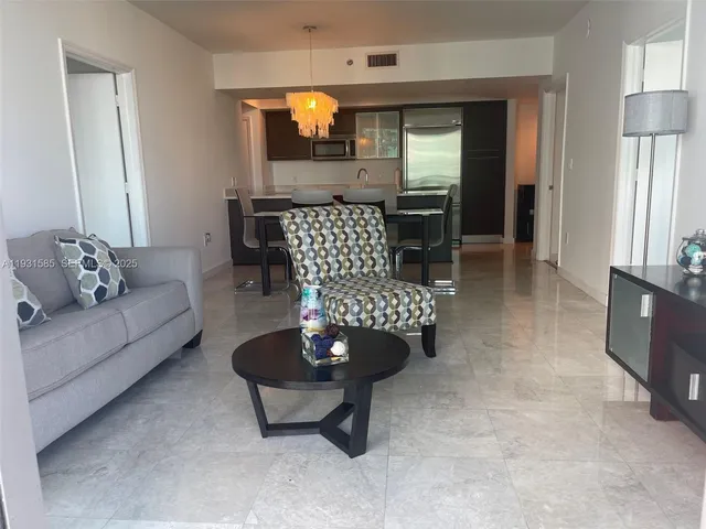 a living room with furniture and a rug