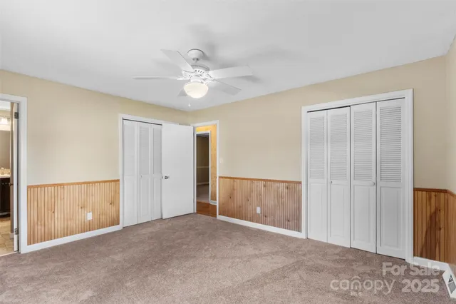 a view of an empty room with a ceiling fan