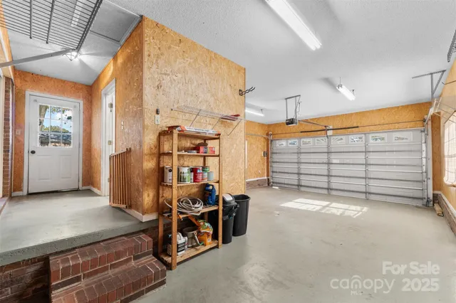 a view of an empty room with wooden floor and a ceiling fan