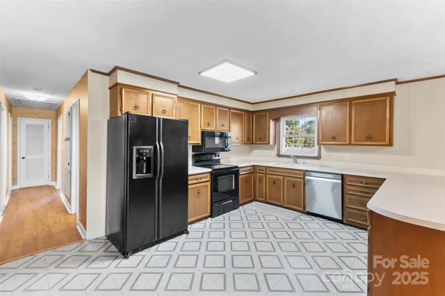 a kitchen with stainless steel appliances granite countertop a refrigerator sink and cabinets