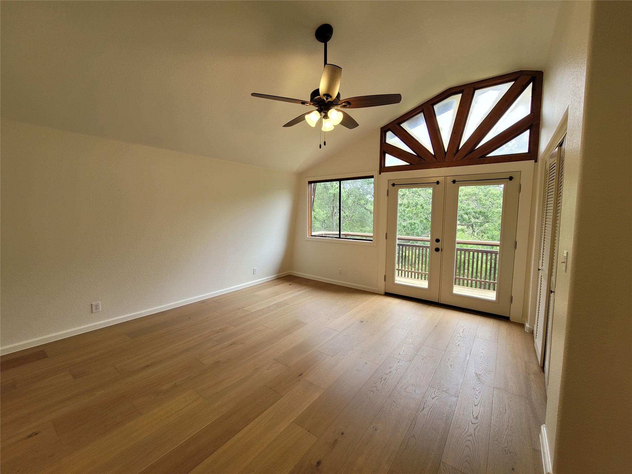 281 Earl Callahan Road, Unit A Cedar Creek, TX 78612 - Photo 20 of 39 a view of an empty room with a window and wooden floor