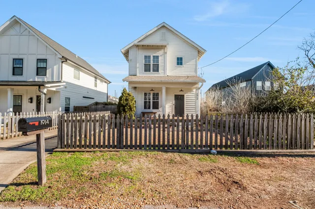 a front view of a house with wooden fence