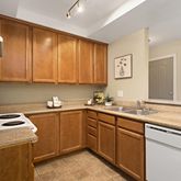 a kitchen with a sink stove top oven and cabinets