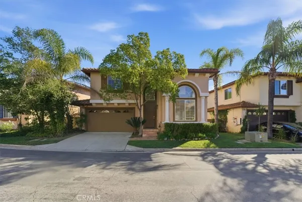 a front view of a house with a yard and a garage