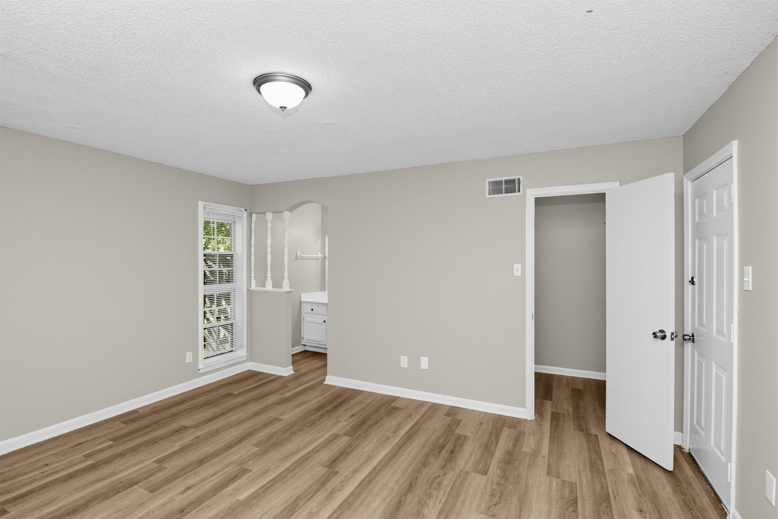 6350 Midsummer Way Memphis, TN 38115 - Photo 13 of 21 Wood-finish flooring, neutral wall paint, recessed lighting, white trim, and a built-in vanity with cabinetry