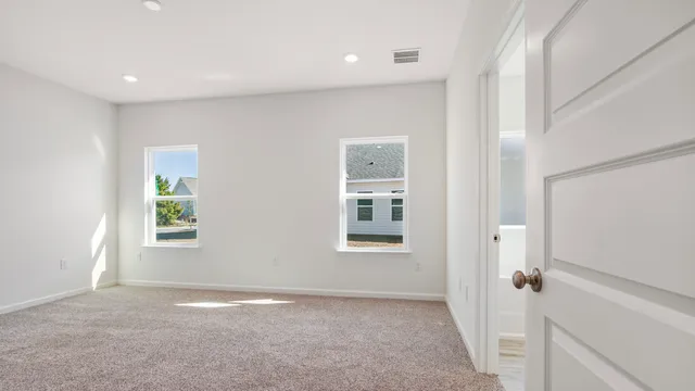 an empty room with windows and closet
