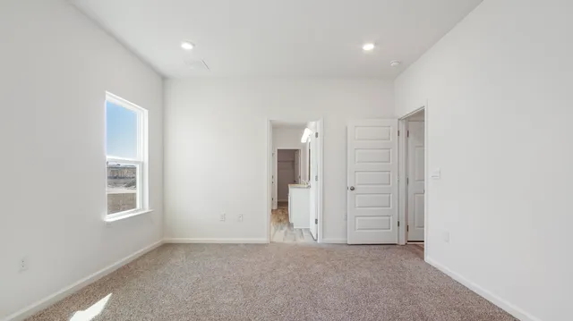 an empty room with windows and closet