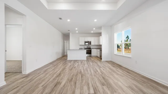 a view of kitchen with wooden floor electronic appliances and window