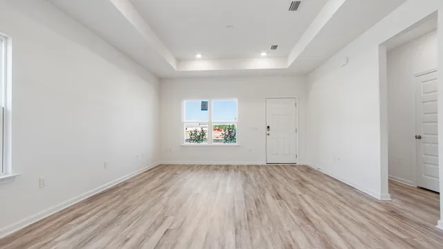 wooden floor in an empty room with a window