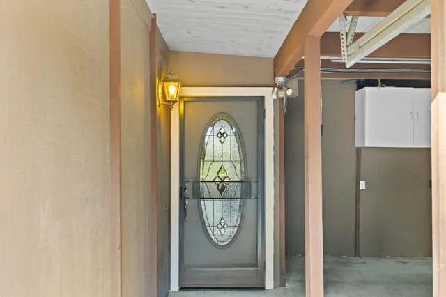 a hallway with a dining table and a large window