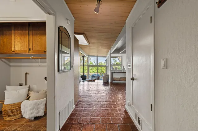 a bathroom with a sink a mirror a toilet and a window