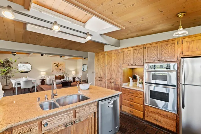 a kitchen with stainless steel appliances a refrigerator and a sink