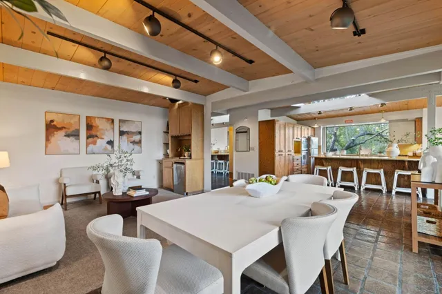 a living room with furniture and painting on the wall