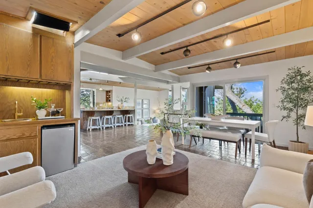 a living room with furniture and a floor to ceiling window