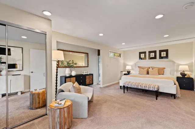 a spacious bedroom with a bed and a large window