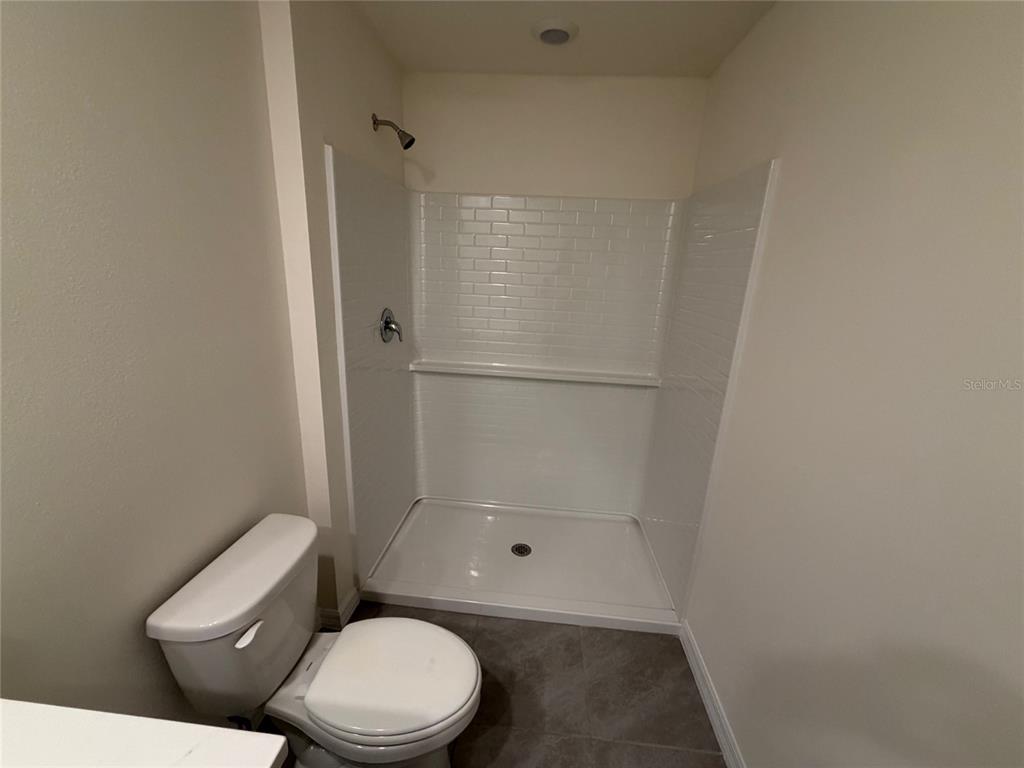 6685 South W 81st Loop Ocala, FL 34476 - Photo 14 of 31 a white toilet sitting next to a shower