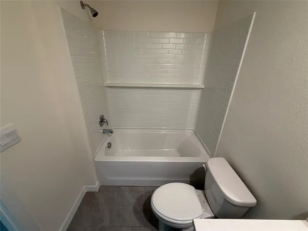 a bathroom with a sink mirror vanity and toilet
