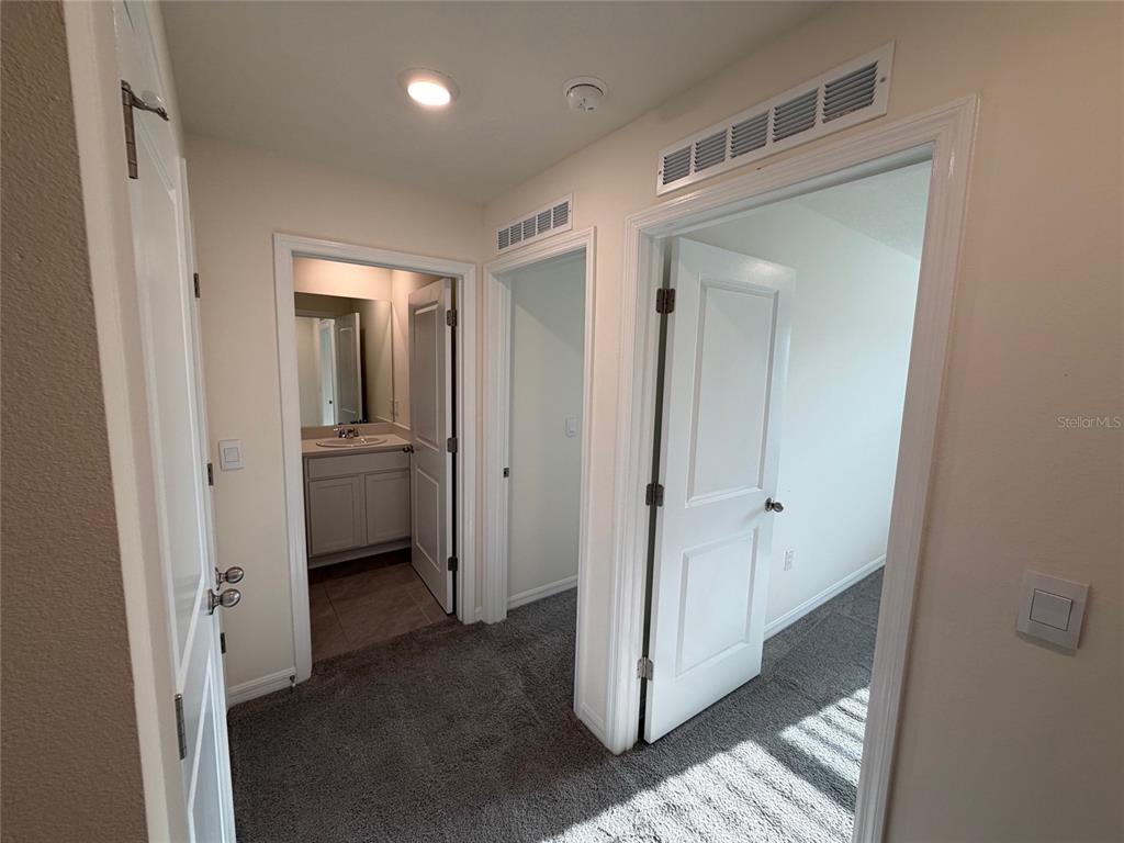 6685 South W 81st Loop Ocala, FL 34476 - Photo 23 of 31 a view of a hallway with a glass door and a bathroom