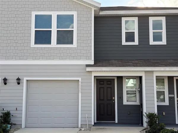 a view of a white house in a city street