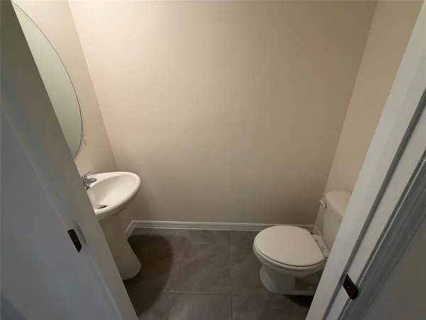 a white toilet sitting next to a white sink