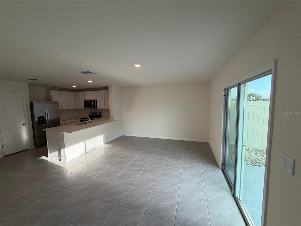 6685 South W 81st Loop Ocala, FL 34476 - Photo 8 of 31 a large kitchen with a refrigerator and a counter top space