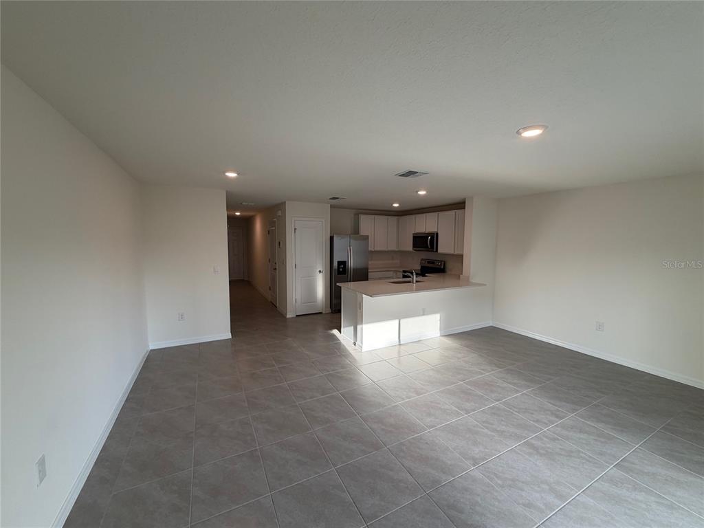 6685 South W 81st Loop Ocala, FL 34476 - Photo 10 of 31 a view of kitchen with refrigerator and window