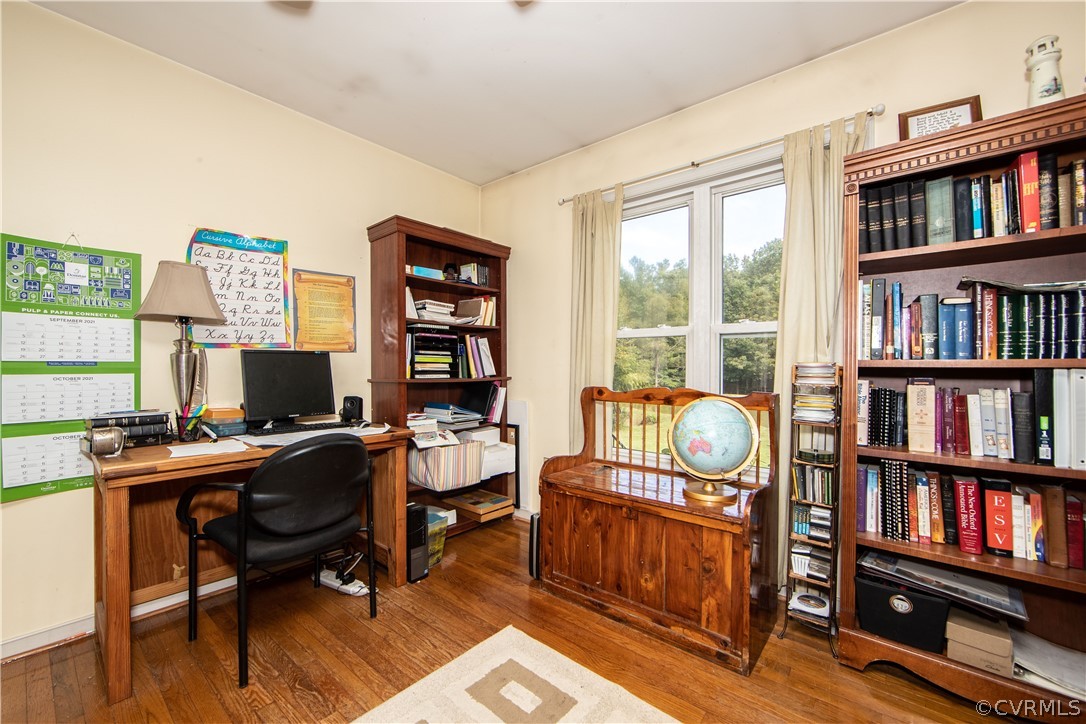 10014 Colemans Lake Road Ford, VA 23850 - Photo 13 of 28 a view of a workspace with furniture and a book shelf