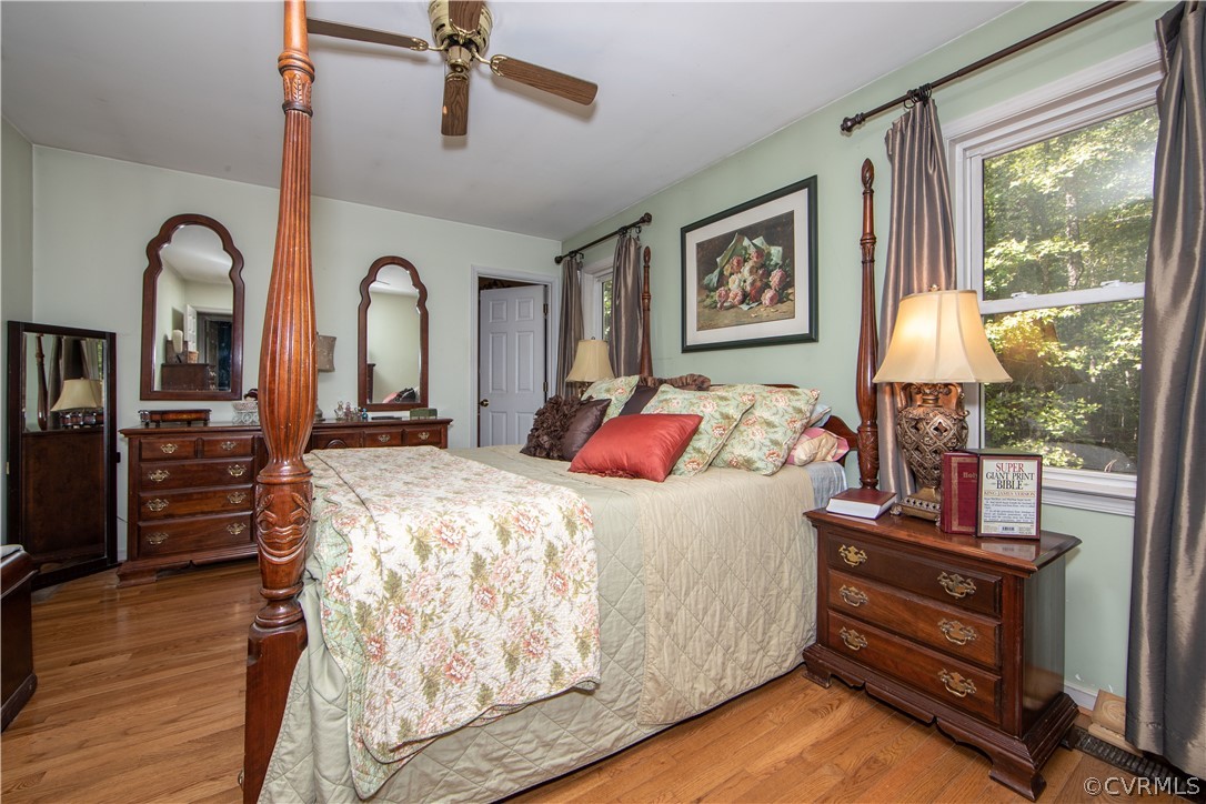 10014 Colemans Lake Road Ford, VA 23850 - Photo 18 of 28 a bedroom with a bed and wooden floor
