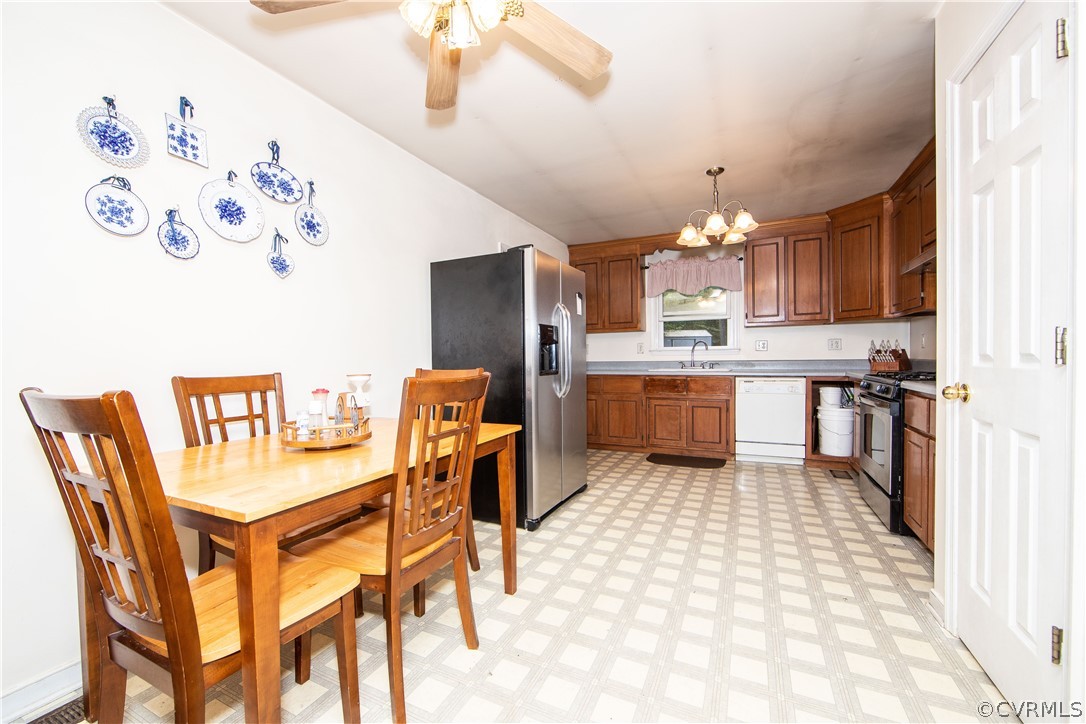 10014 Colemans Lake Road Ford, VA 23850 - Photo 6 of 28 a kitchen with a dining table chairs and refrigerator