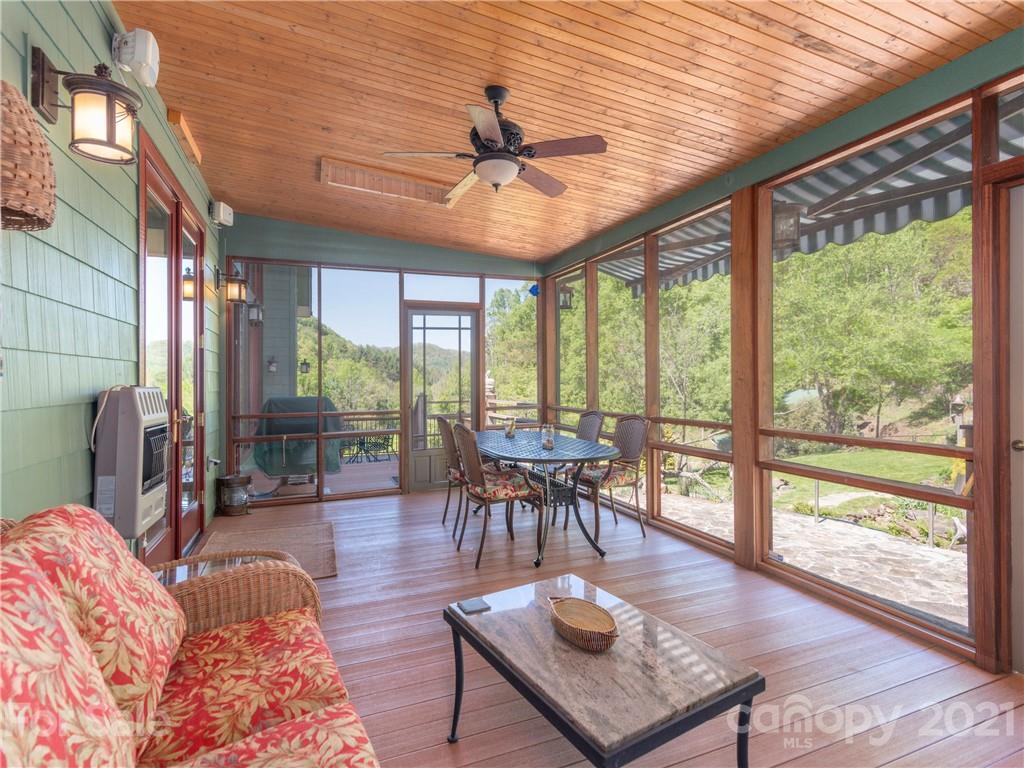122 Jump Cove Road Weaverville, NC 28787 - Photo 12 of 48 a living room with furniture a ceiling fan and a large window