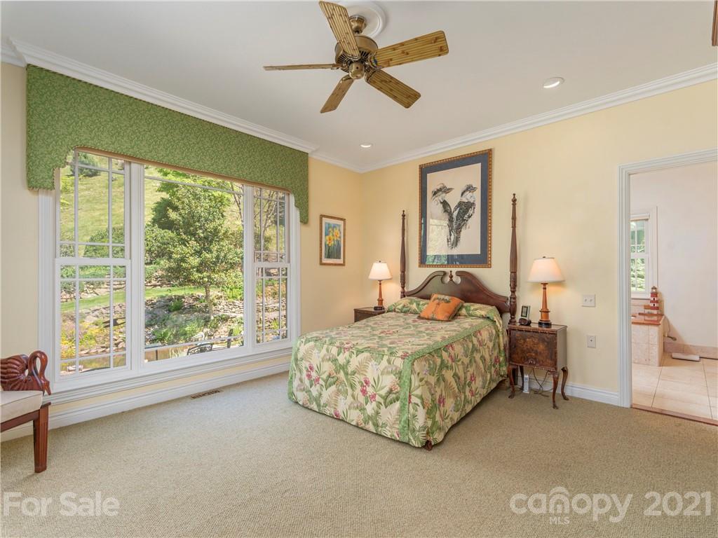 122 Jump Cove Road Weaverville, NC 28787 - Photo 18 of 48 a bedroom with a large bed and a large window