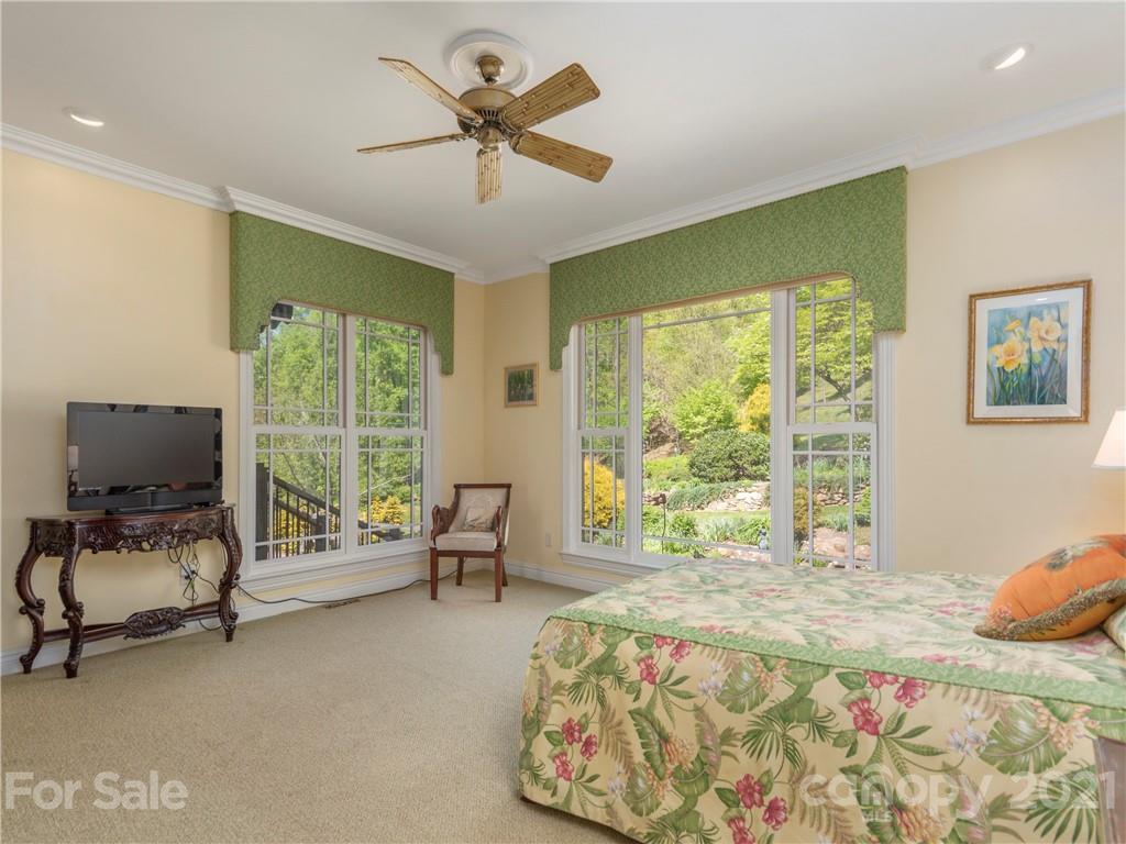 122 Jump Cove Road Weaverville, NC 28787 - Photo 19 of 48 a bedroom with a bed and large windows