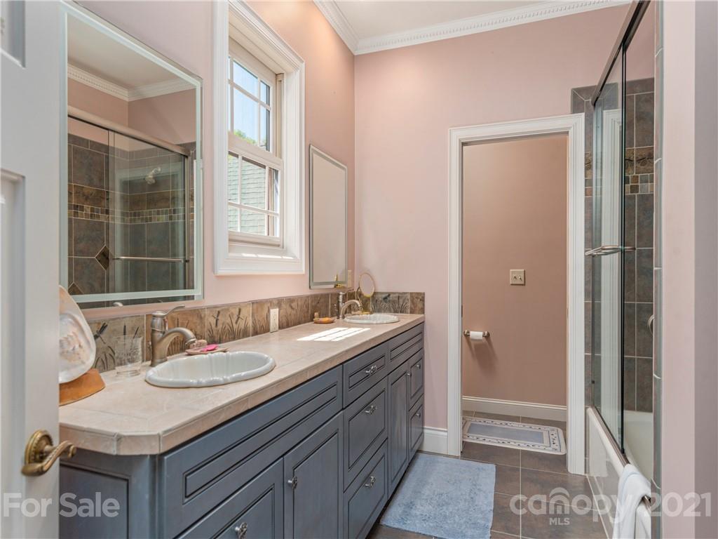 122 Jump Cove Road Weaverville, NC 28787 - Photo 24 of 48 a bathroom with a sink double vanity and a mirror