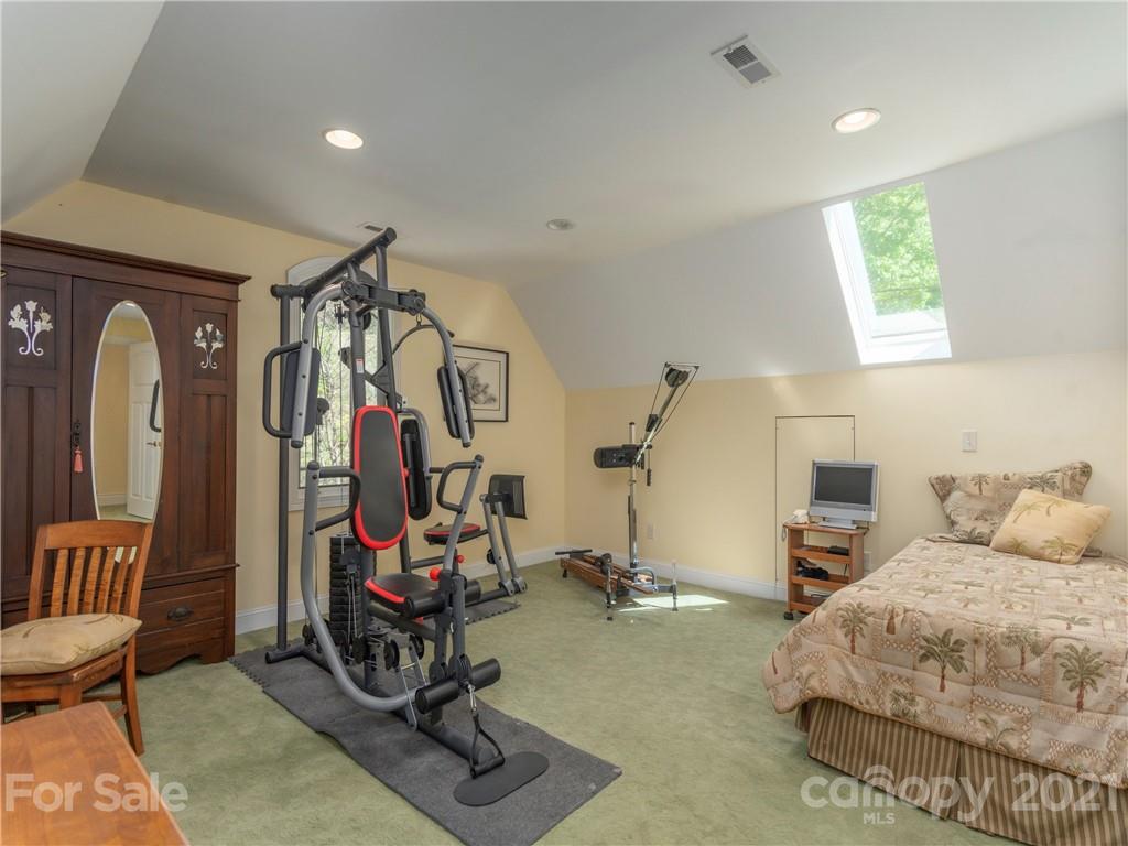 122 Jump Cove Road Weaverville, NC 28787 - Photo 26 of 48 a bedroom with bed and glass windows