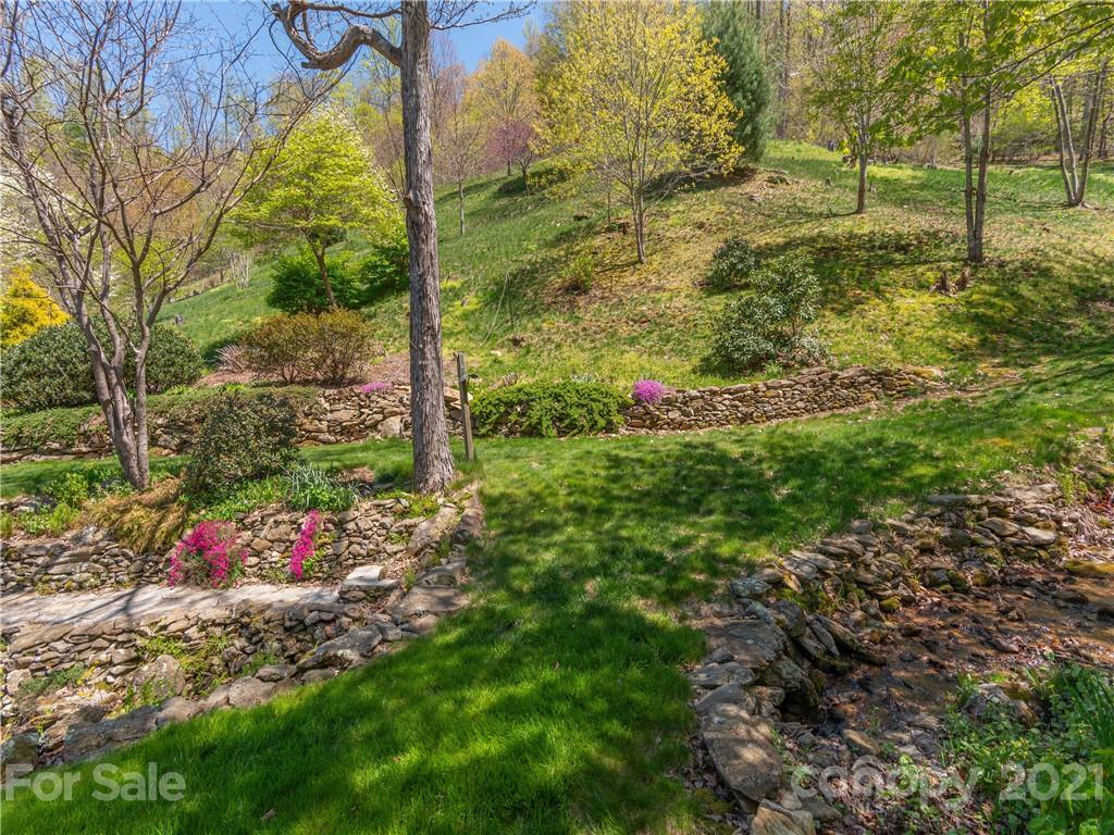 122 Jump Cove Road Weaverville, NC 28787 - Photo 29 of 48 a backyard of a house with lots of green space