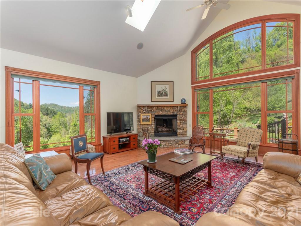122 Jump Cove Road Weaverville, NC 28787 - Photo 4 of 48 a living room with furniture fireplace and a large window