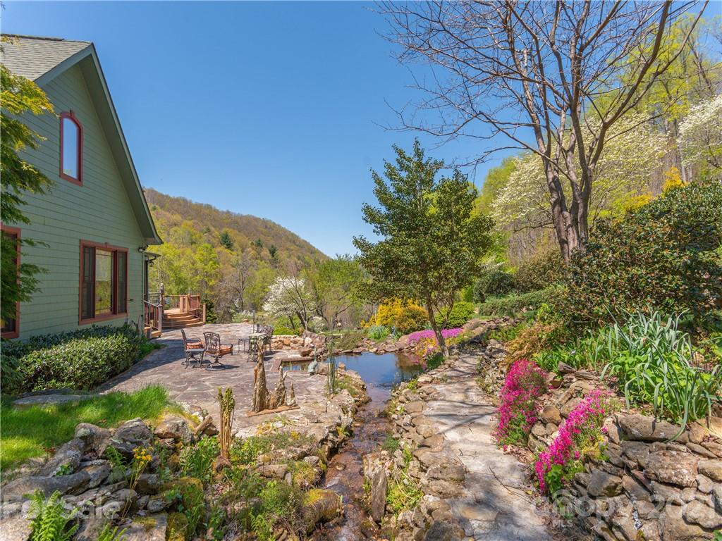 122 Jump Cove Road Weaverville, NC 28787 - Photo 31 of 48 a view of a chair and table in the backyard