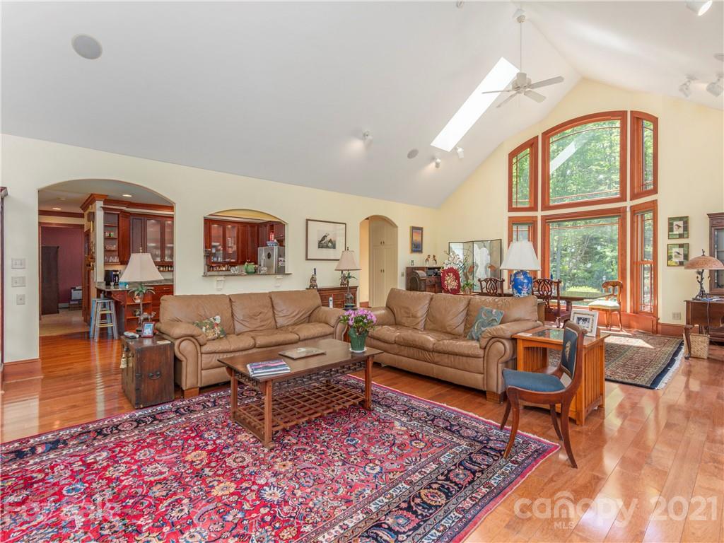 122 Jump Cove Road Weaverville, NC 28787 - Photo 6 of 48 a living room with furniture a rug and a large window
