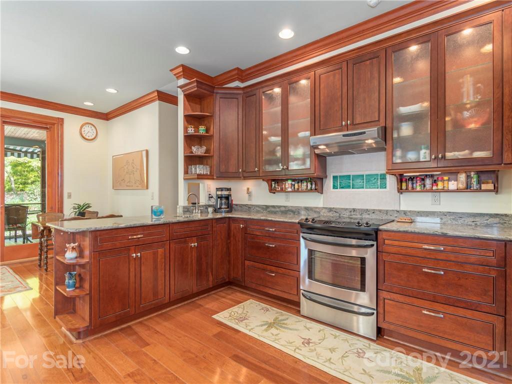122 Jump Cove Road Weaverville, NC 28787 - Photo 8 of 48 a kitchen with stainless steel appliances granite countertop a stove a sink and a microwave