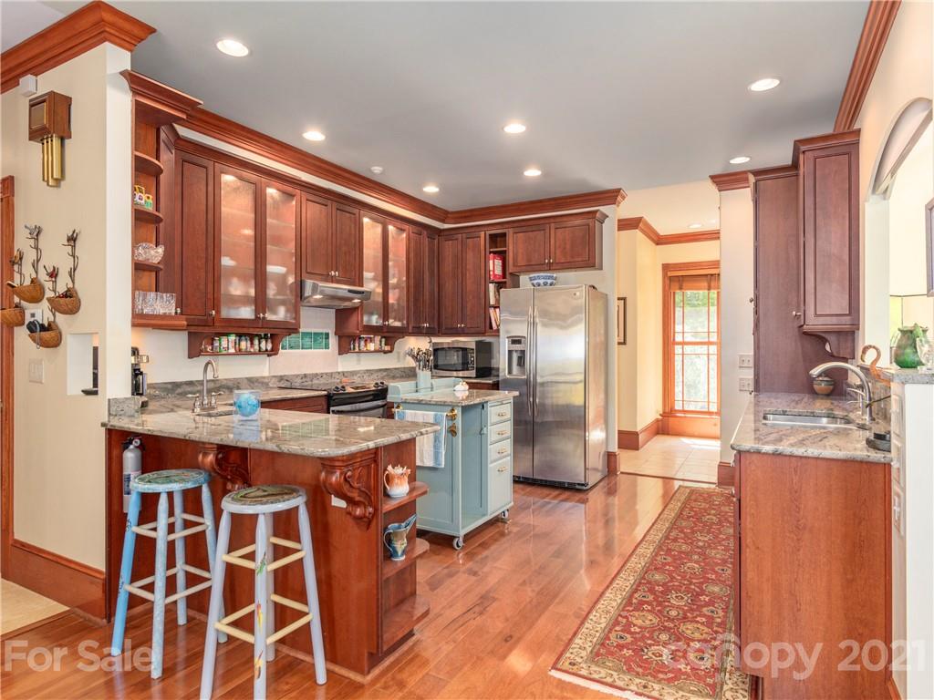 122 Jump Cove Road Weaverville, NC 28787 - Photo 10 of 48 a kitchen with a sink stove and refrigerator