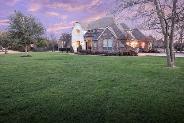 a view of a big yard with a house in the background