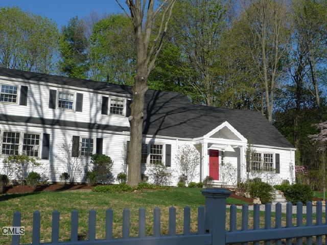 2 Rustic Lane Westport, CT 06880 - Photo 1 of 1 a front view of house with yard and green space
