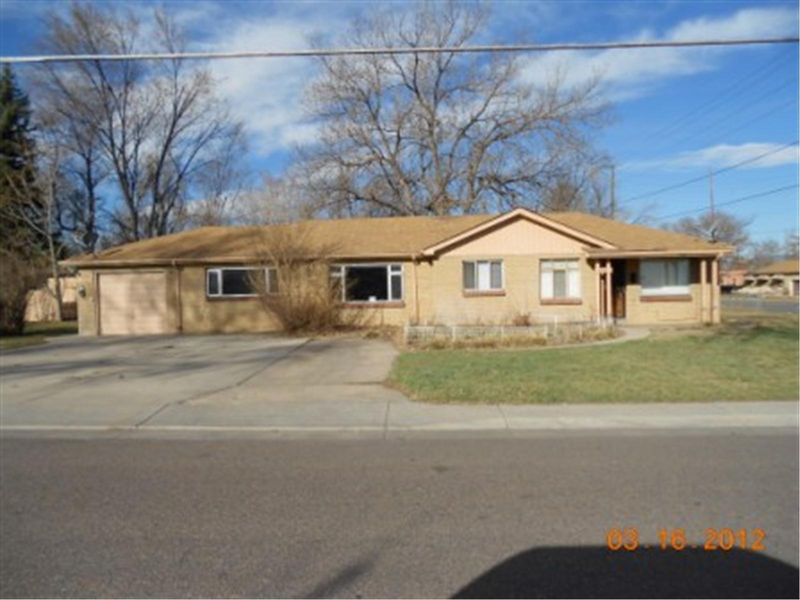 4395 Reed Street Wheat Ridge, CO 80033 - Photo 1 of 1 a front view of a house with a yard and garage
