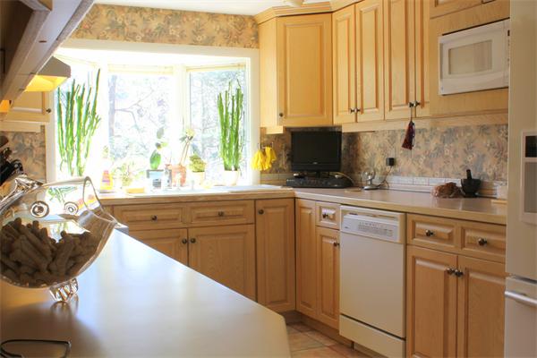 11 Algonquin Road Canton, MA 02021 - Photo 8 of 17 a kitchen with stainless steel appliances a sink a stove and white cabinets with wooden floor