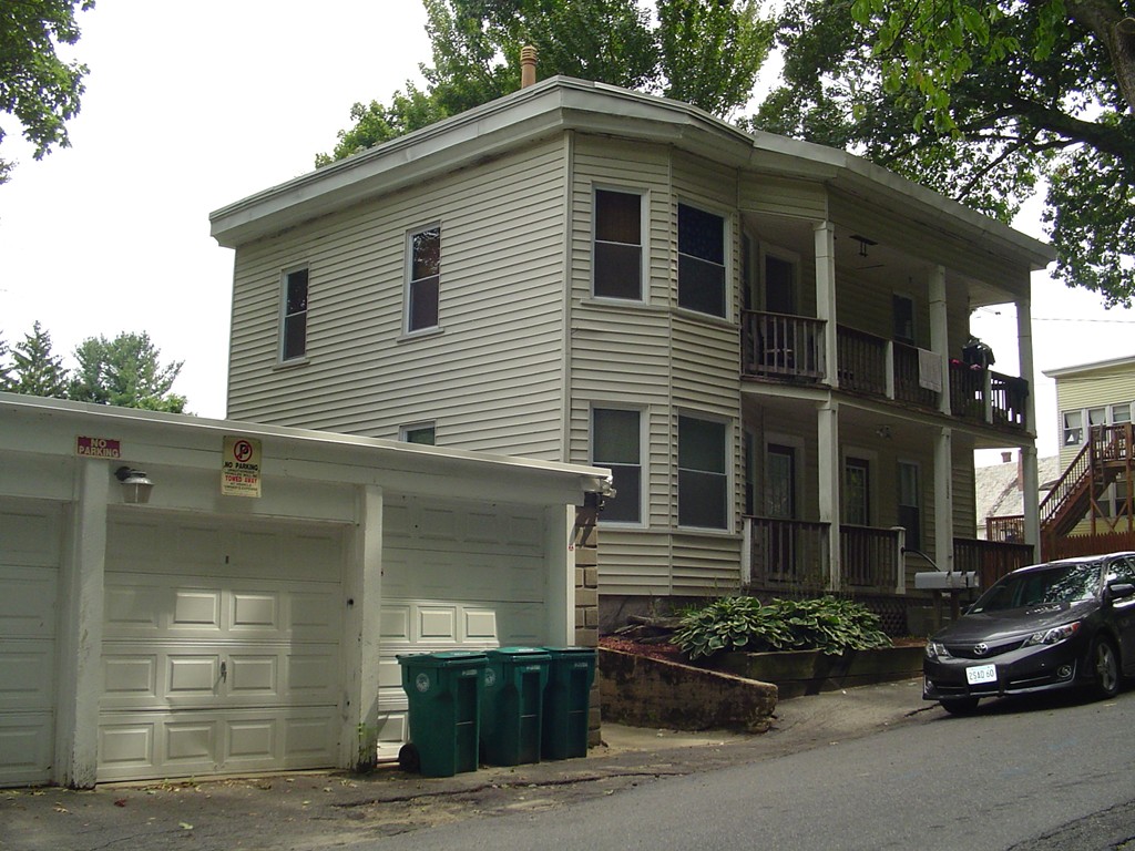 132 Hazel Street Fitchburg, MA 01420 - Photo 1 of 13 a front view of a house with garage