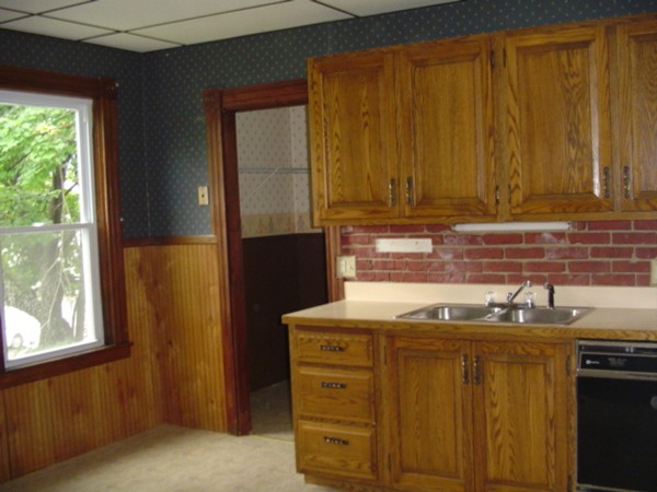 132 Hazel Street Fitchburg, MA 01420 - Photo 2 of 13 a kitchen with stainless steel appliances wooden cabinets and a sink