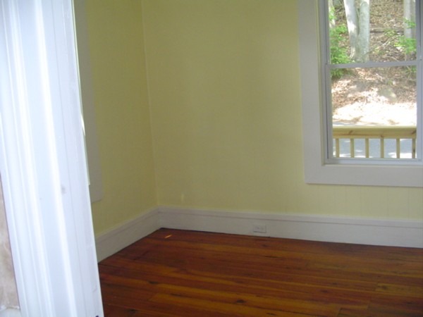 132 Hazel Street Fitchburg, MA 01420 - Photo 5 of 13 a view of a small space with wooden floor and a window