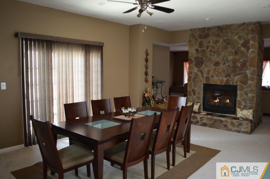 72 Stafford Road Colonia, NJ 07067 - Photo 3 of 20 a view of a dining room with furniture and a fireplace