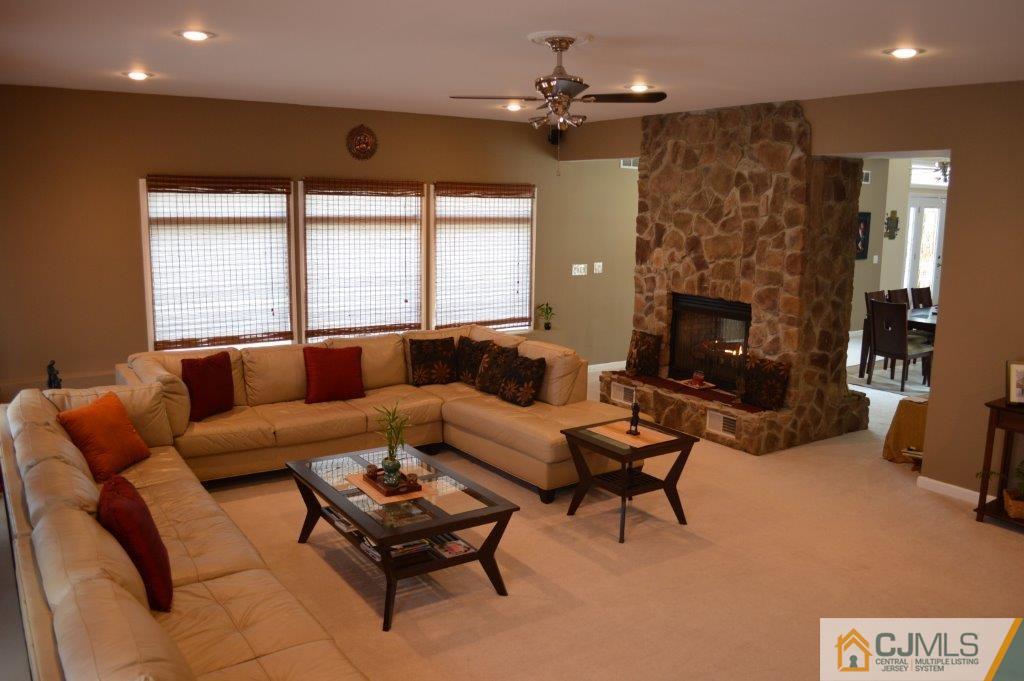 72 Stafford Road Colonia, NJ 07067 - Photo 5 of 20 a living room with furniture and a fireplace